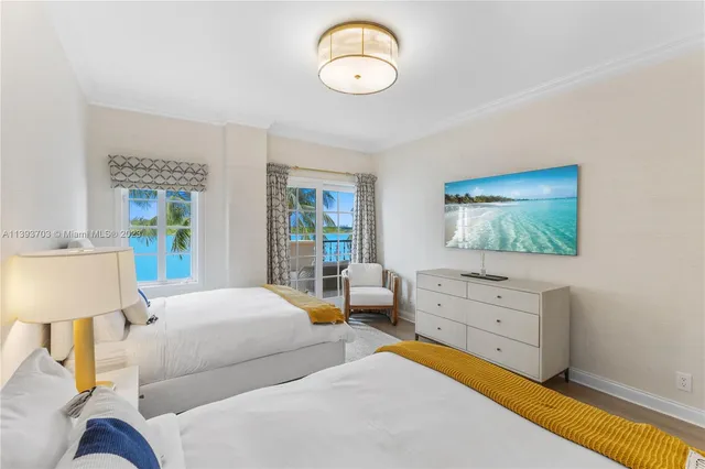 a bedroom with two beds and a window