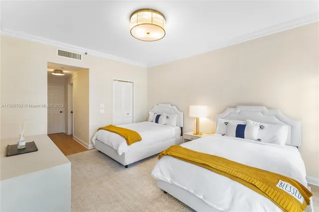 a bedroom with two beds and a lamp