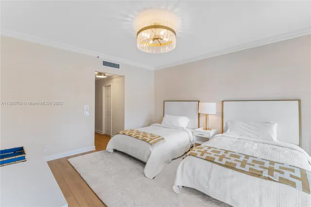 a bedroom with two beds and a lamp