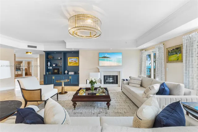 a living room with furniture kitchen view and a window