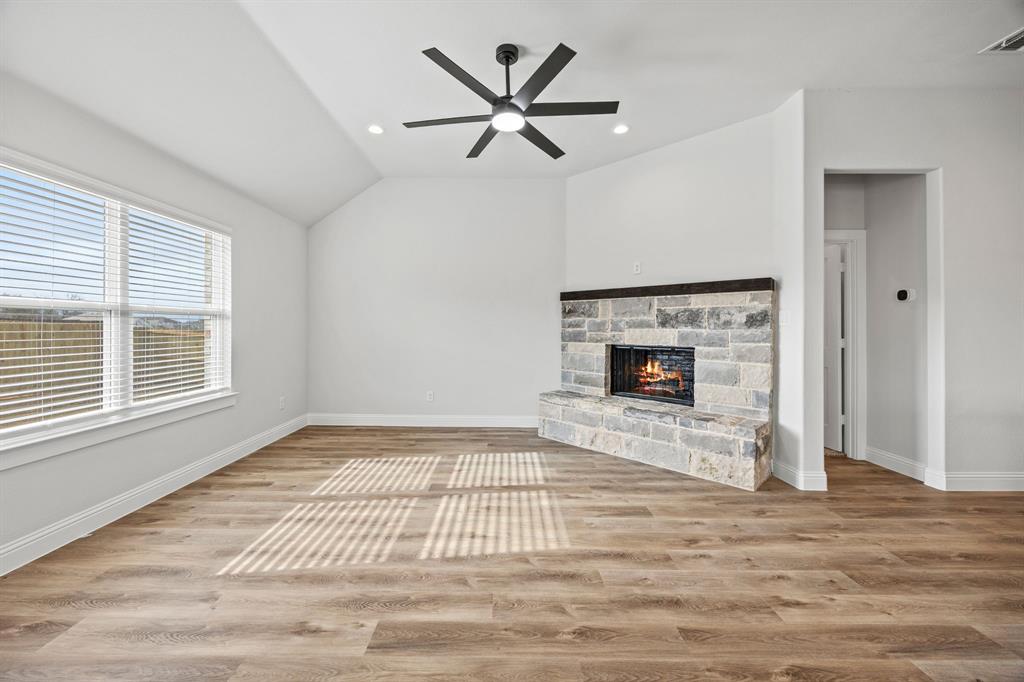102 Maverick Trail Valley View, TX 76272 - Photo 13 of 32 a view of an empty room with a fireplace and a window