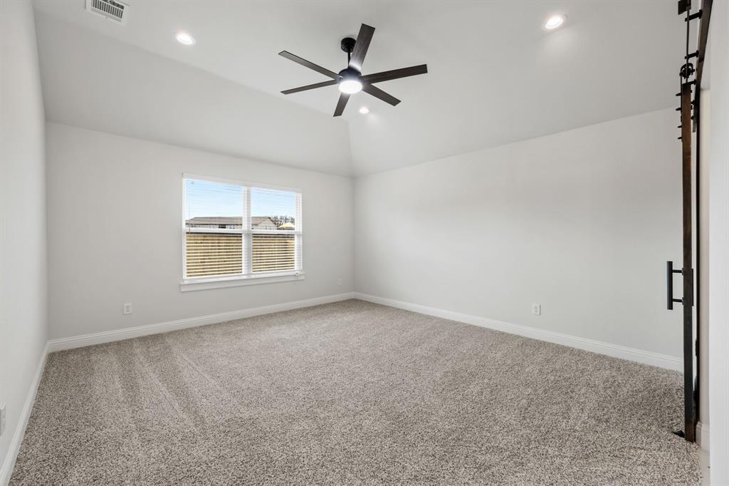 102 Maverick Trail Valley View, TX 76272 - Photo 16 of 32 an empty room with ceiling fan and windows