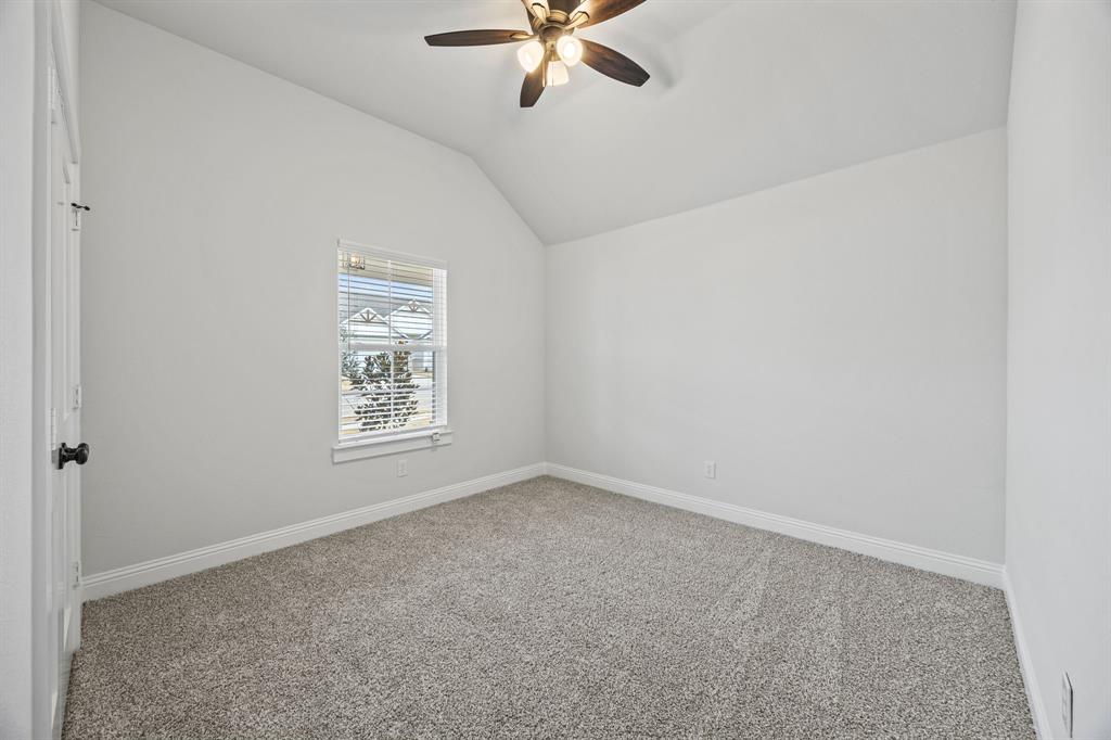 102 Maverick Trail Valley View, TX 76272 - Photo 19 of 32 an empty room with a window and a fan