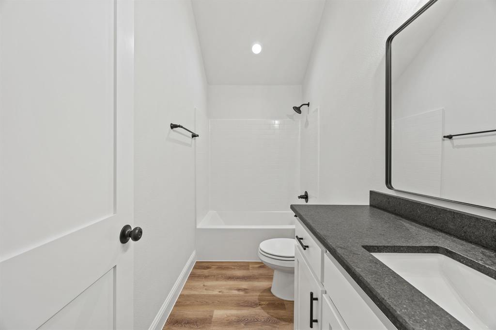 102 Maverick Trail Valley View, TX 76272 - Photo 20 of 32 a bathroom with a sink a toilet and shower