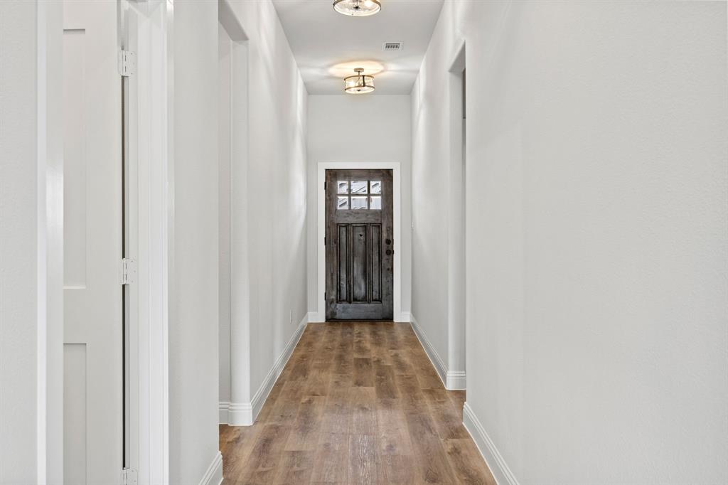 102 Maverick Trail Valley View, TX 76272 - Photo 4 of 32 a view of a hallway with wooden floor