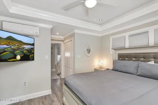 a kitchen with a refrigerator a sink dishwasher a stove and white cabinets with wooden floor