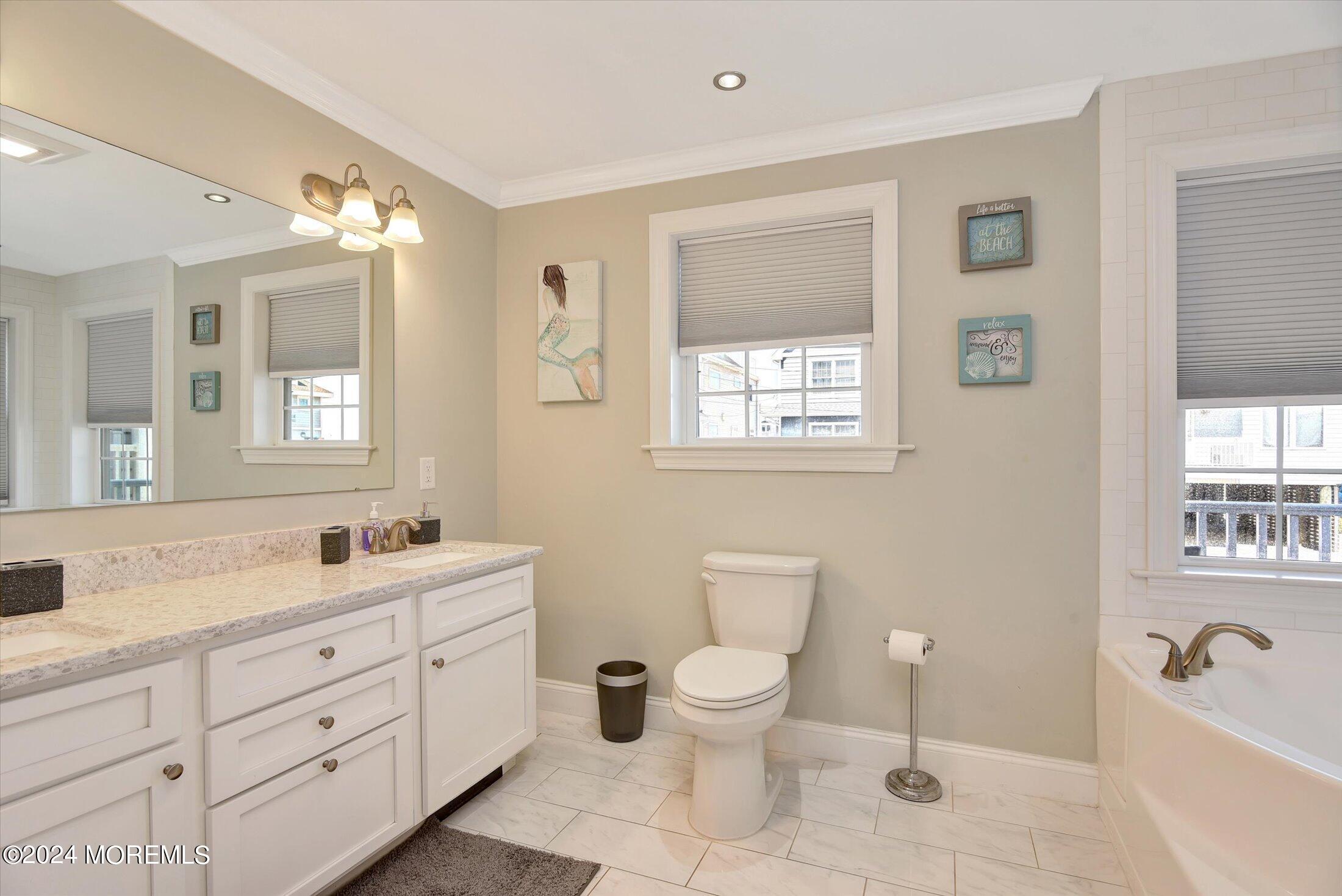 5 Fielder Avenue Seaside Heights, NJ 08751 - Photo 15 of 55 a spacious bathroom with double sink a toilet a window and shower