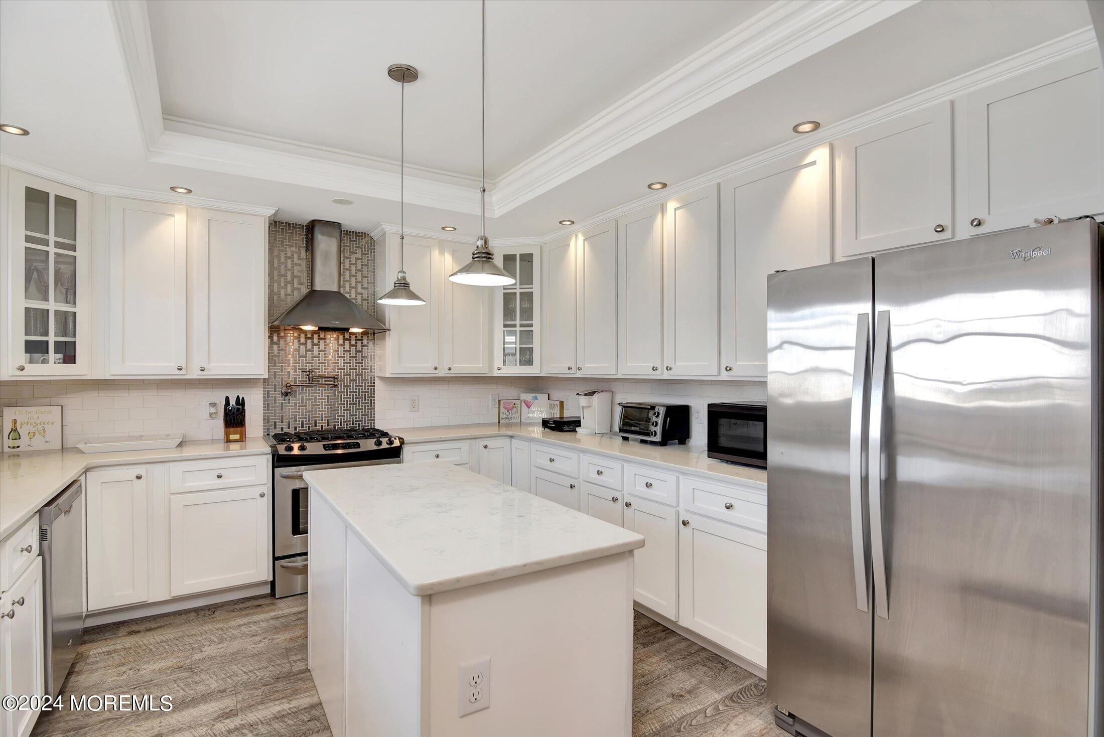 5 Fielder Avenue Seaside Heights, NJ 08751 - Photo 25 of 55 a kitchen with a sink a stove a refrigerator and white cabinets