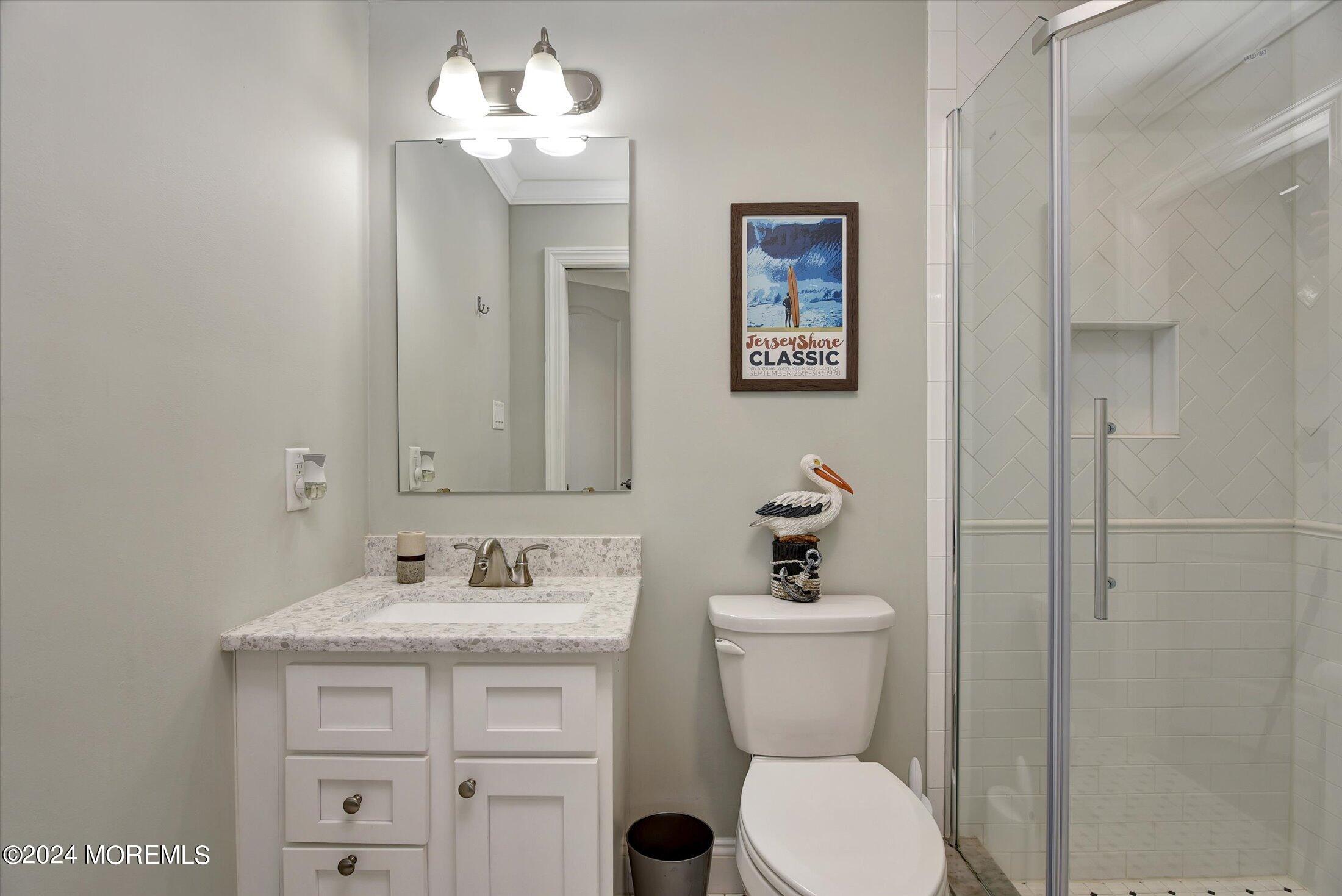 5 Fielder Avenue Seaside Heights, NJ 08751 - Photo 30 of 55 a bathroom with a toilet sink and mirror
