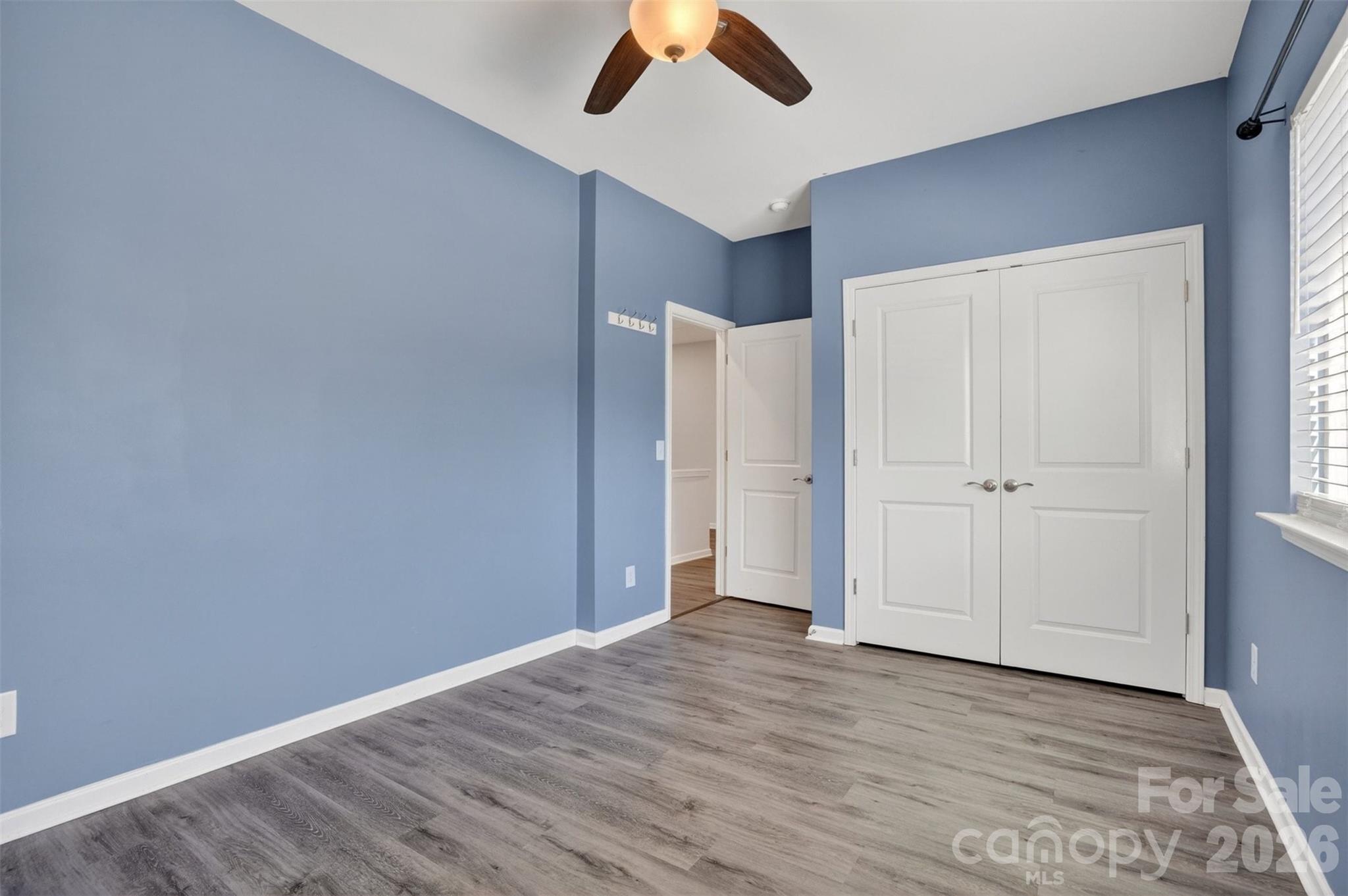 764 River Park Road Belmont, NC 28012 - Photo 18 of 27 an empty room with a ceiling fan and wooden floor