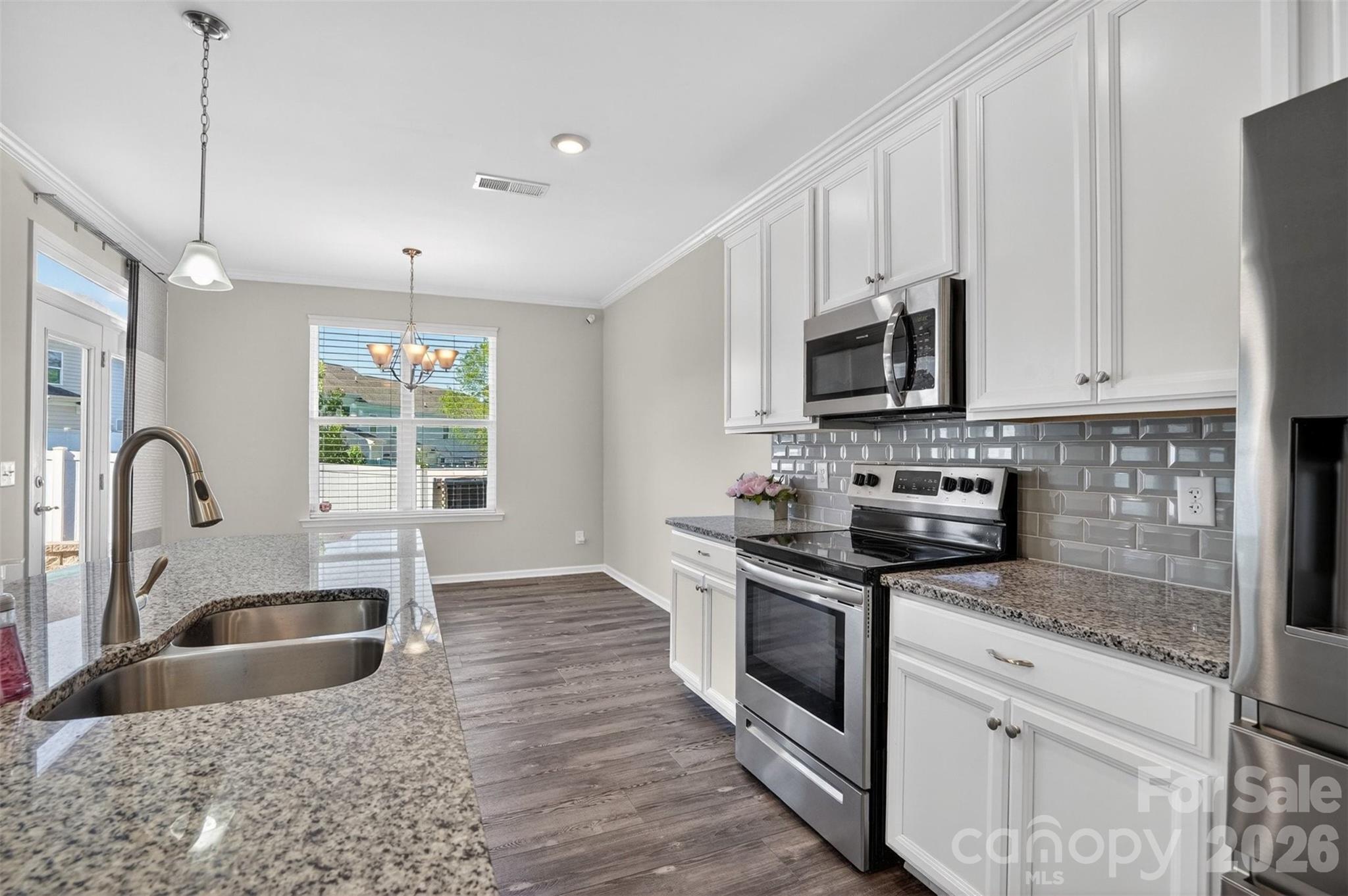 764 River Park Road Belmont, NC 28012 - Photo 8 of 27 a kitchen with granite countertop a stove a sink and a microwave