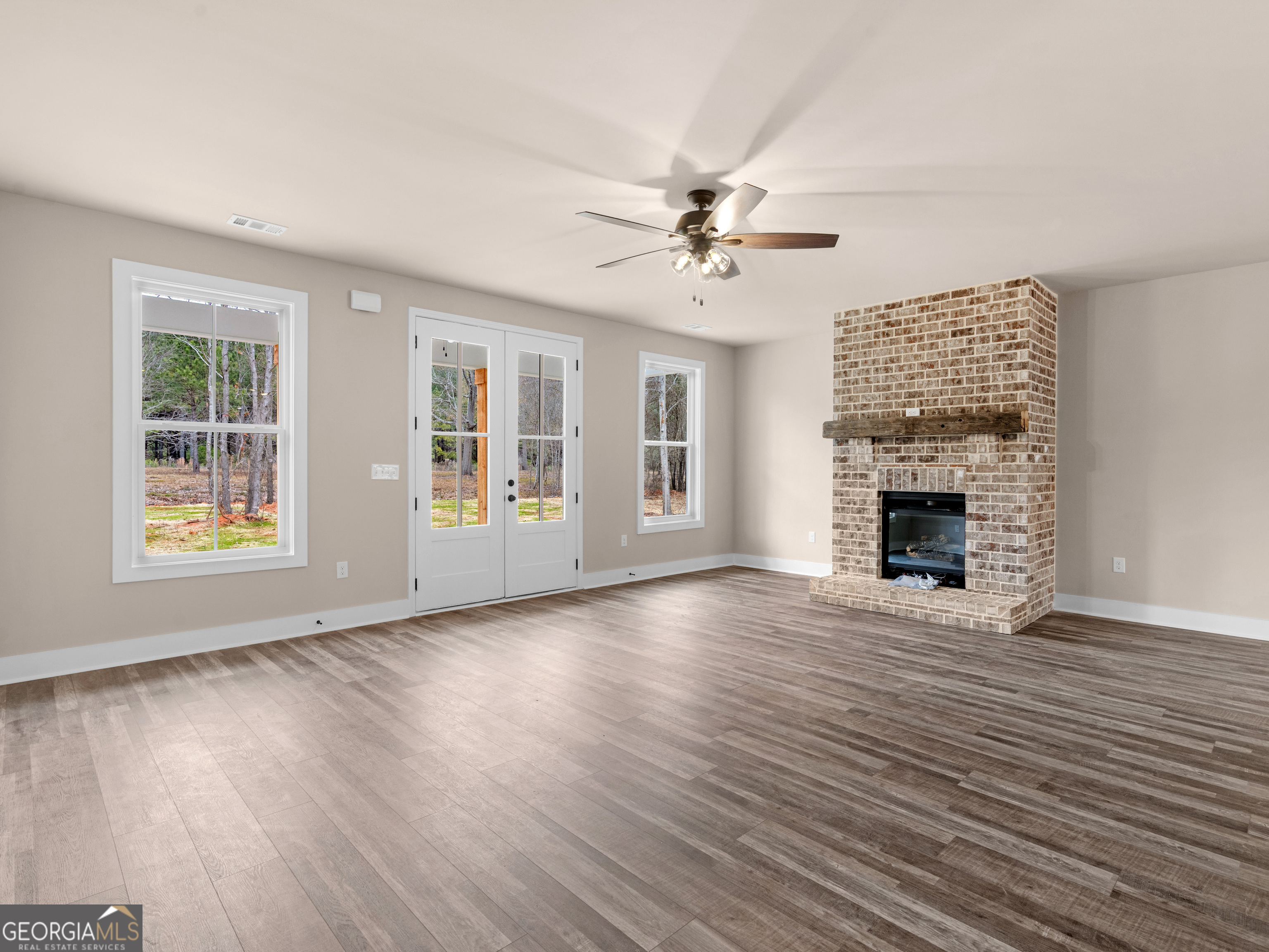 160 Loyd Road Mansfield, GA 30056 - Photo 16 of 53 a view of an empty room with window and wooden floor