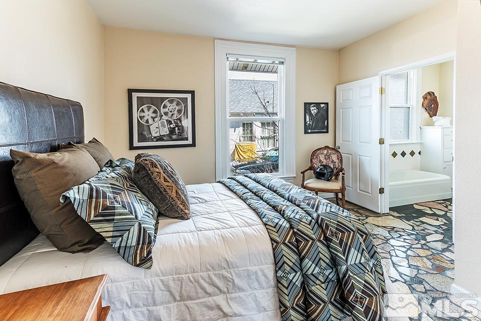 635 South Arlington Avenue Reno, NV 89509 - Photo 11 of 25 a bedroom with a bed and a couch