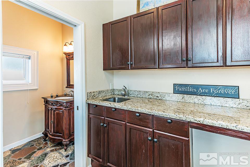 635 South Arlington Avenue Reno, NV 89509 - Photo 13 of 25 a kitchen with a sink a stove and cabinets