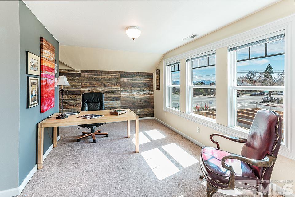 635 South Arlington Avenue Reno, NV 89509 - Photo 20 of 25 a living room with furniture a fireplace and a floor to ceiling window