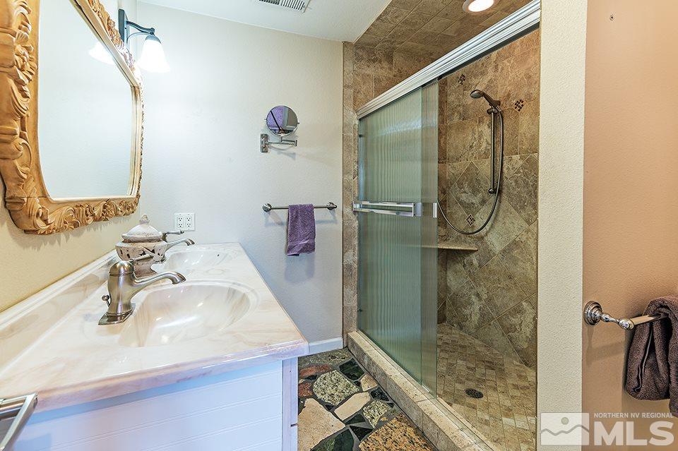 635 South Arlington Avenue Reno, NV 89509 - Photo 21 of 25 a bathroom with a sink and a mirror