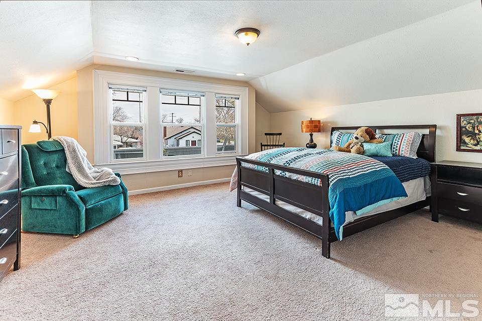 635 South Arlington Avenue Reno, NV 89509 - Photo 22 of 25 a bedroom with a bed and a large window