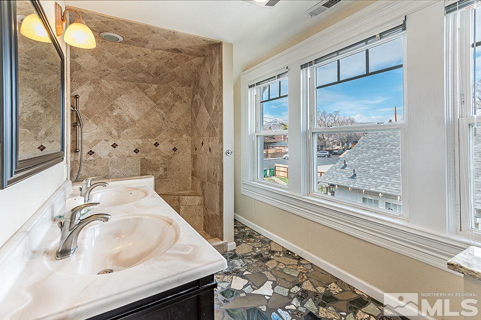 635 South Arlington Avenue Reno, NV 89509 - Photo 23 of 25 a bathroom with a sink and a large mirror
