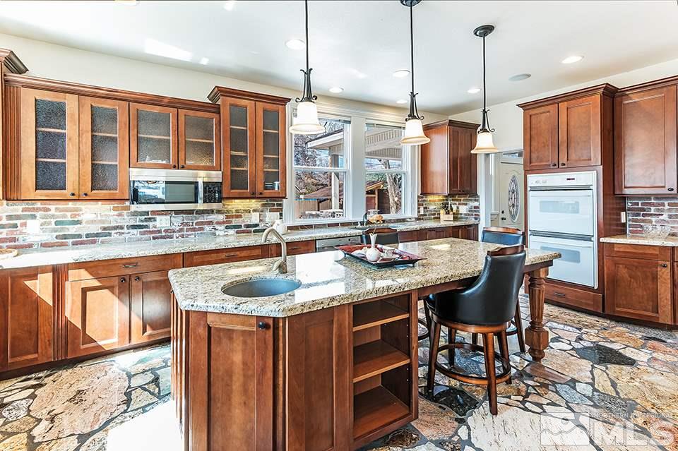 635 South Arlington Avenue Reno, NV 89509 - Photo 10 of 25 a kitchen with stainless steel appliances granite countertop a sink and a wooden cabinets