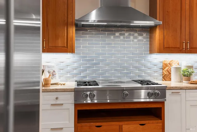 a stove top oven sitting inside of a kitchen