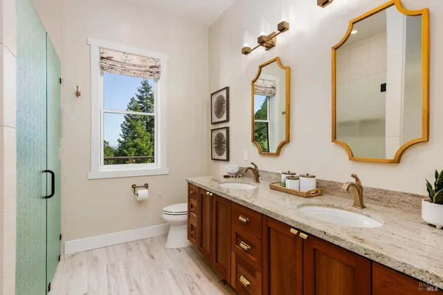 a bathroom with a granite countertop sink mirror and a bathtub