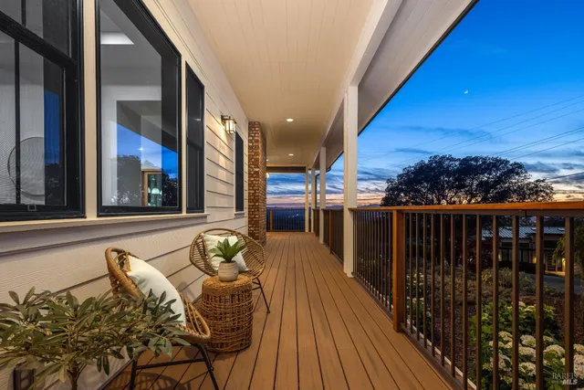 a balcony with table and chairs