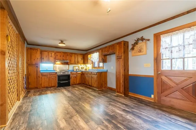 an empty room with windows and cabinet