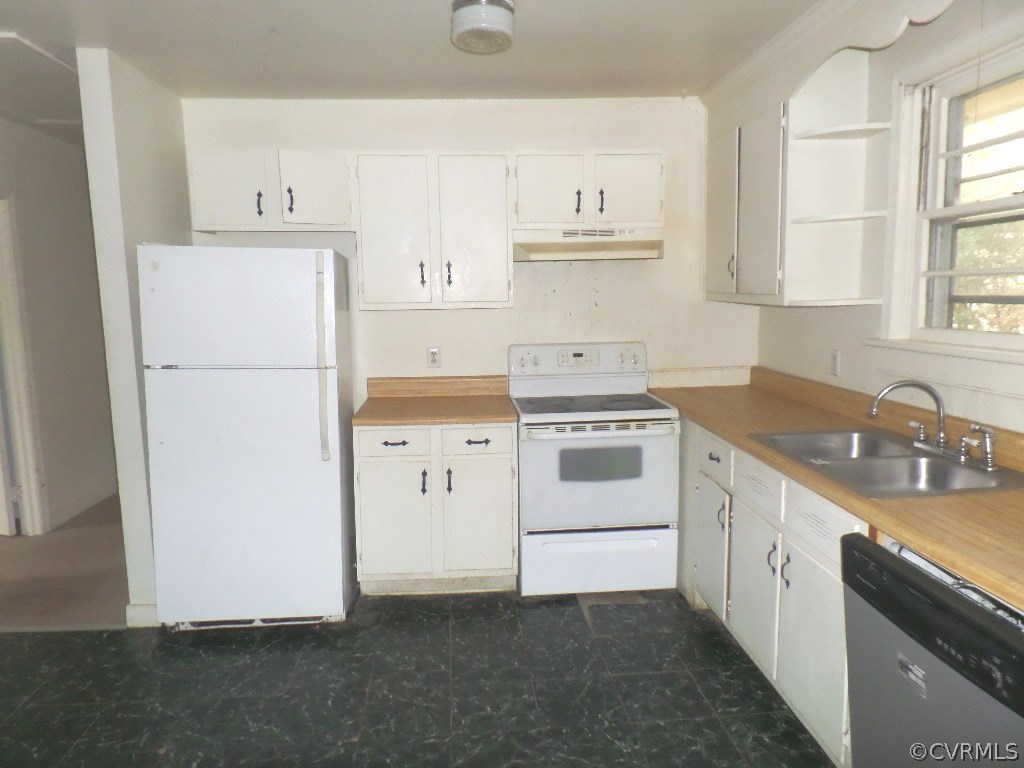 21300 Rutledge Avenue Petersburg, VA 23803 - Photo 10 of 21 a kitchen with a sink a stove a refrigerator and white cabinets