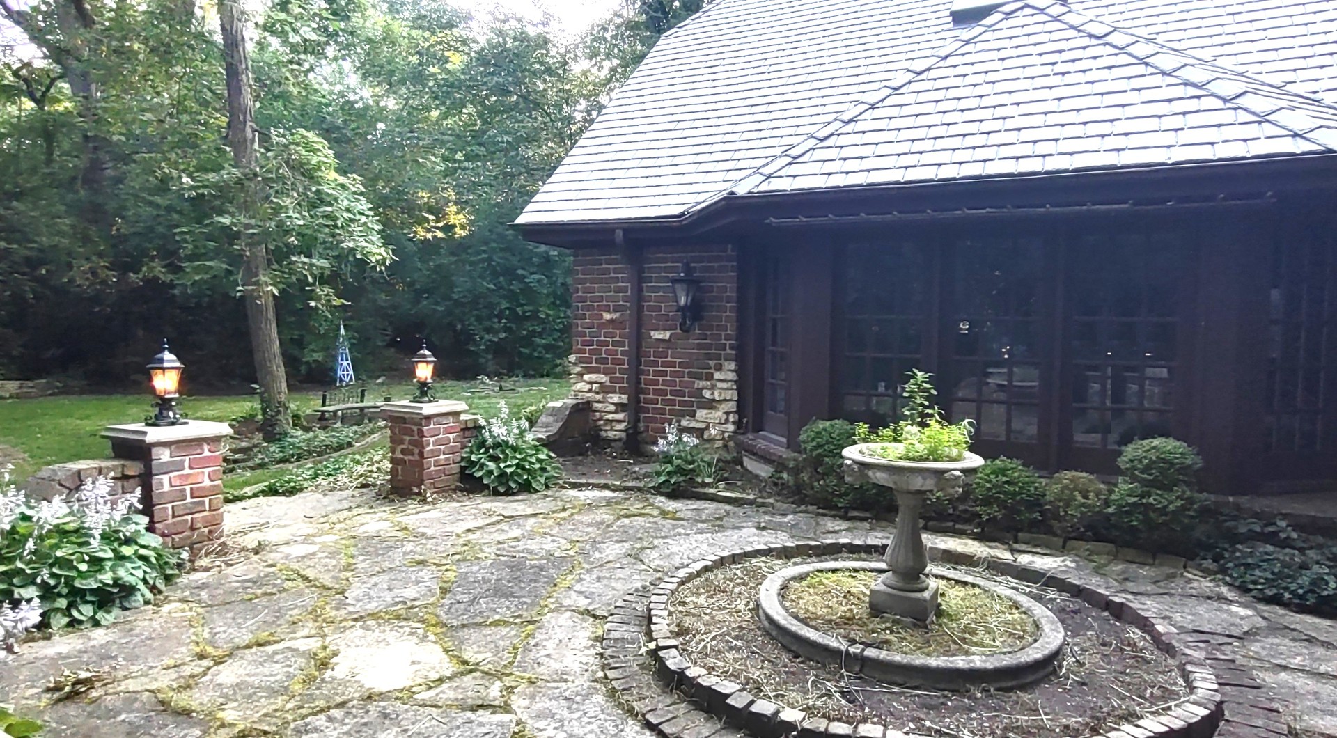 27W161 Mack Road Wheaton, IL 60189 - Photo 33 of 39 a front view of a house with a yard fountain fire pit and outdoor seating
