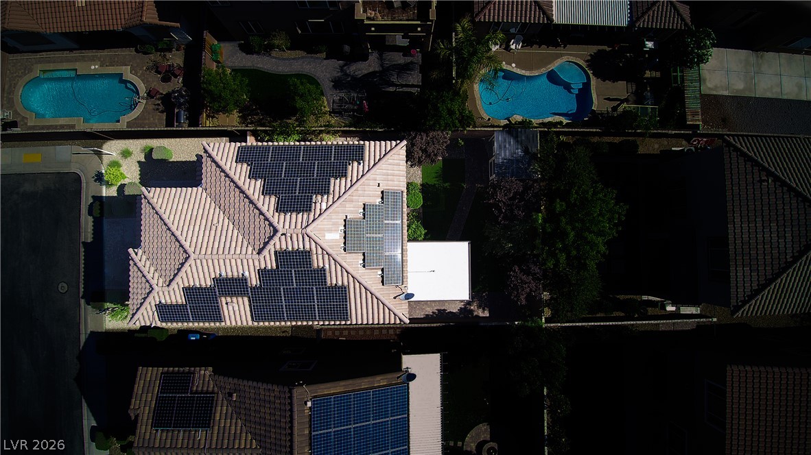 11045 Elk Sands Road Las Vegas, NV 89179 - Photo 64 of 67 An aerial perspective showcases the tiled roof equipped with extensive solar panels.