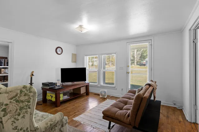 a living room with furniture and a flat screen tv