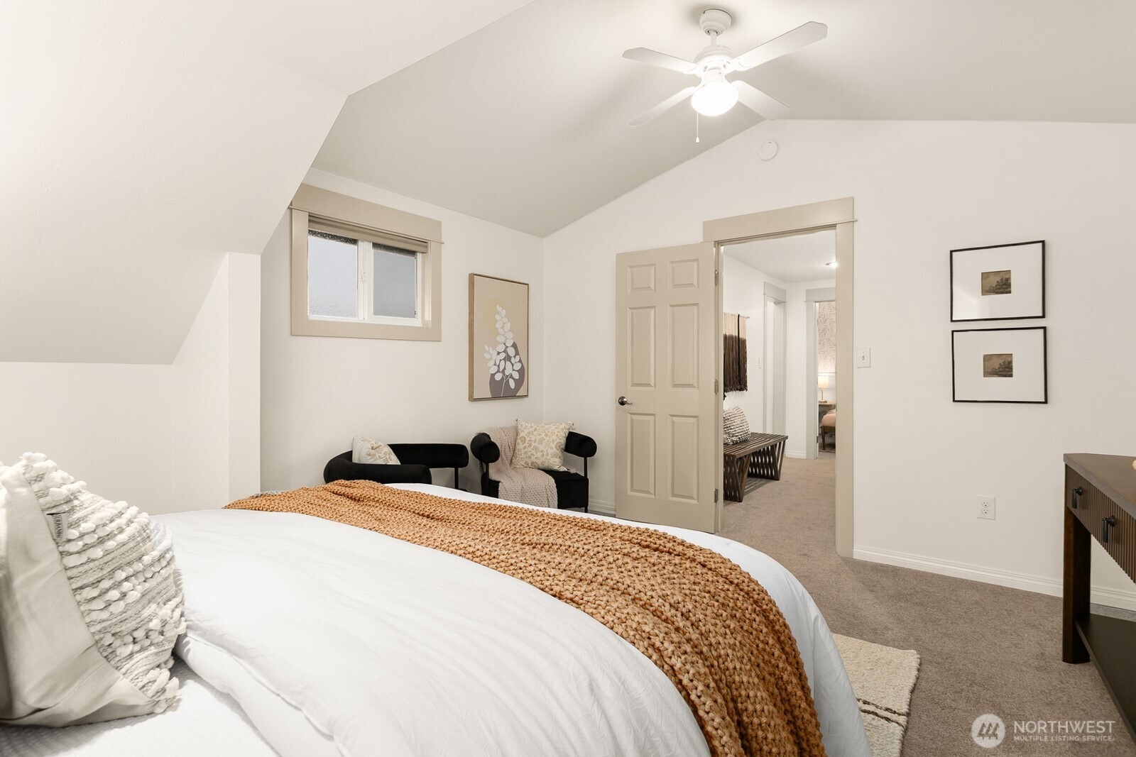20008 101st Place Northeast Bothell, WA 98011 - Photo 12 of 23 a bedroom with a bed and a chandelier