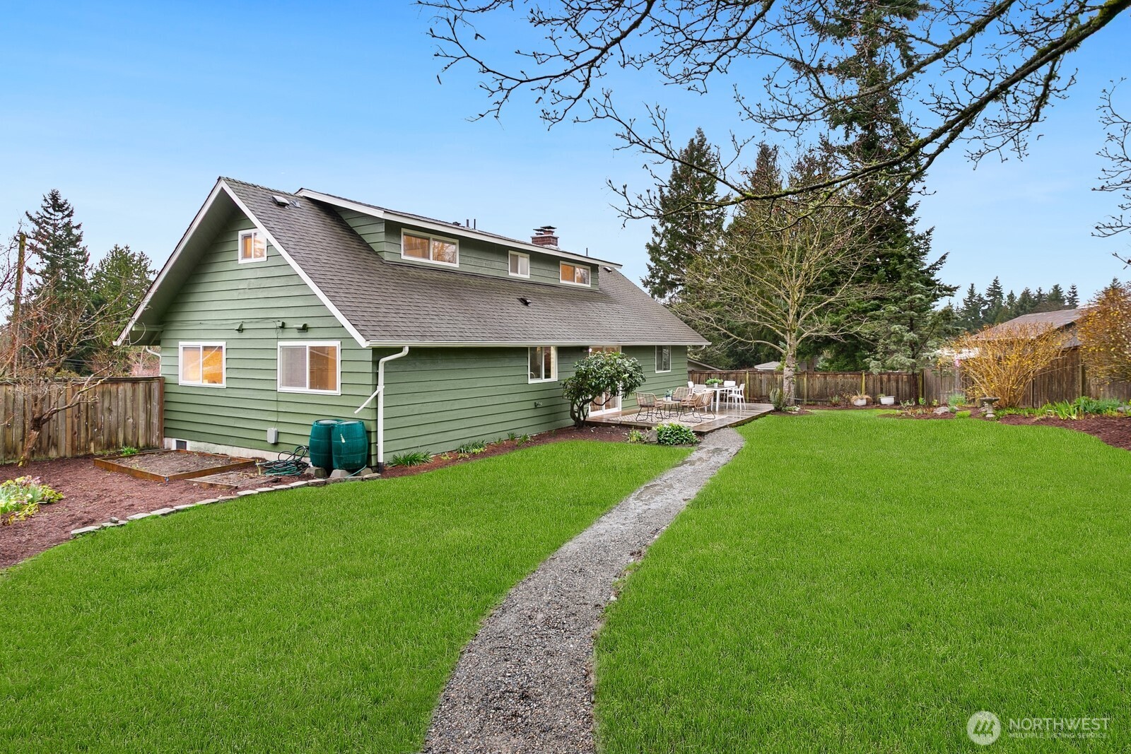 20008 101st Place Northeast Bothell, WA 98011 - Photo 20 of 23 a front view of a house with a garden and trees