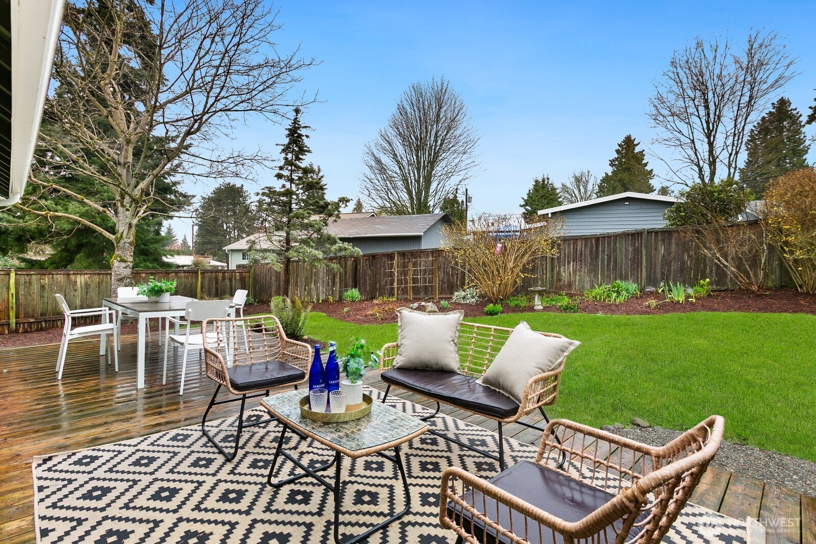20008 101st Place Northeast Bothell, WA 98011 - Photo 21 of 23 a view of a patio with a dining table and chairs with a fire pit and a yard