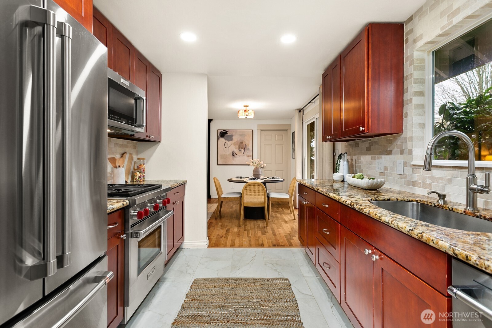20008 101st Place Northeast Bothell, WA 98011 - Photo 8 of 23 a kitchen with stainless steel appliances granite countertop a stove refrigerator sink and microwave