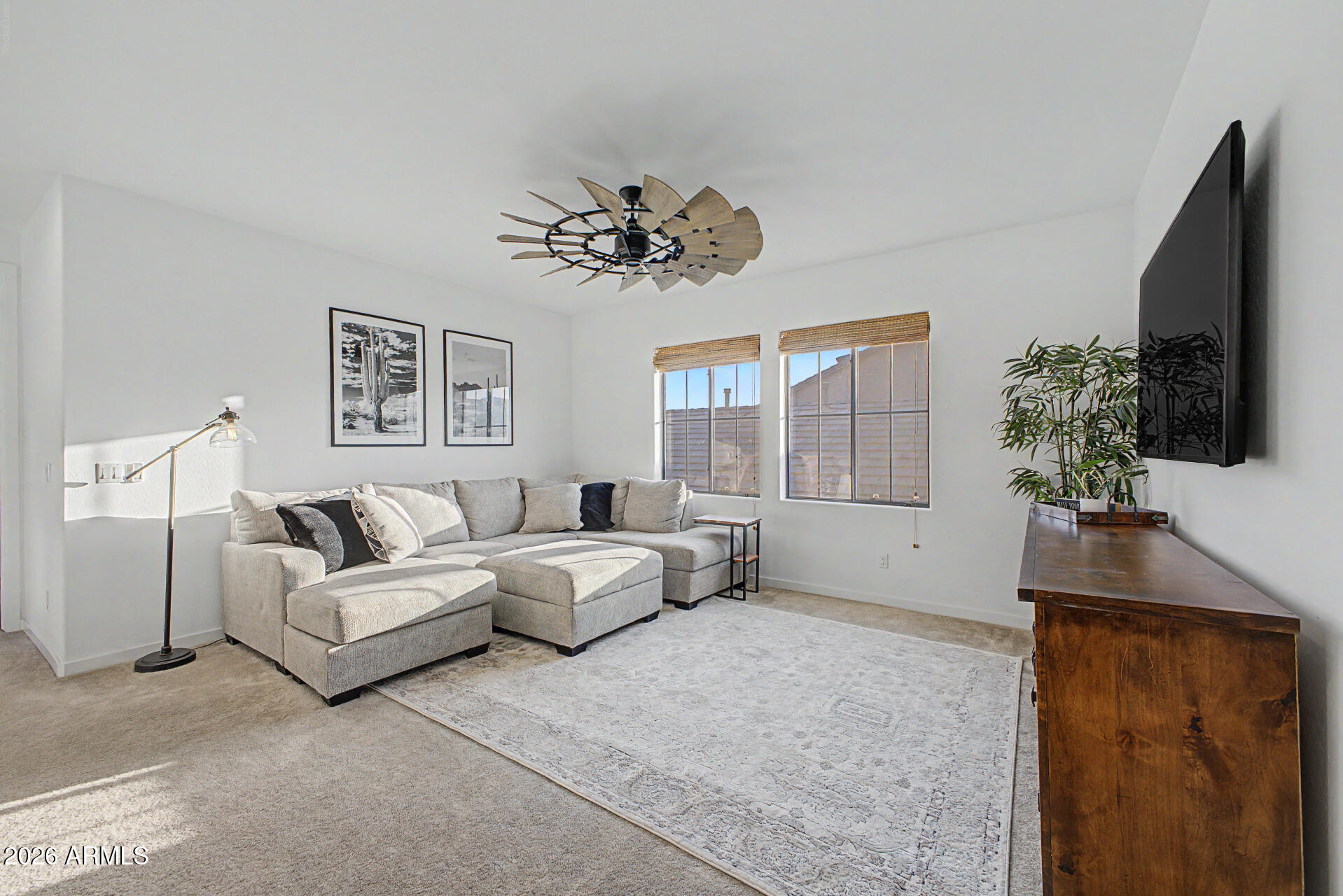 819 West Deer Creek Road Phoenix, AZ 85048 - Photo 45 of 76 a living room with furniture a large window and a flat screen tv