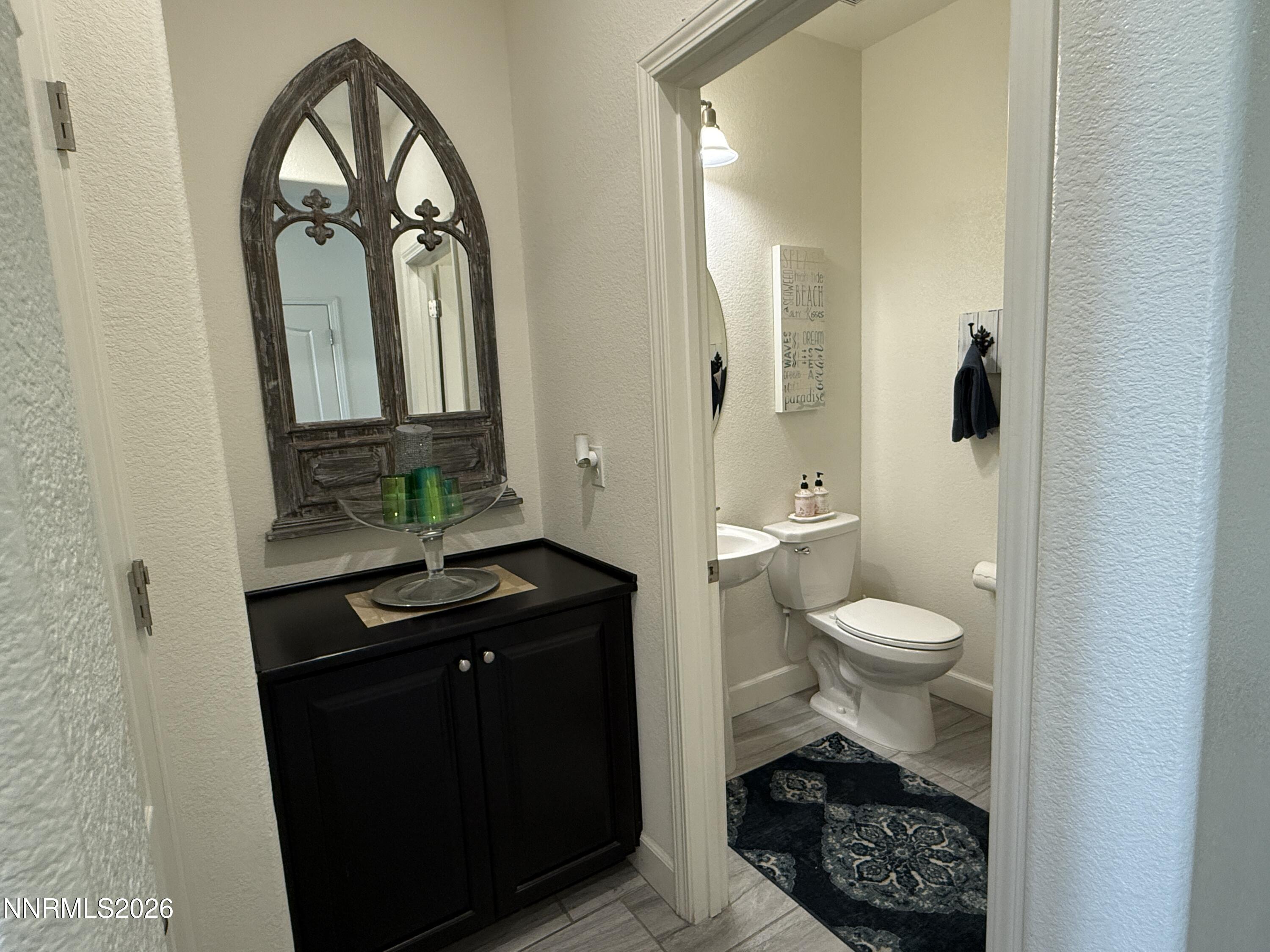 9766 Pachuca Drive Reno, NV 89521 - Photo 16 of 59 a bathroom with a toilet a sink and mirror