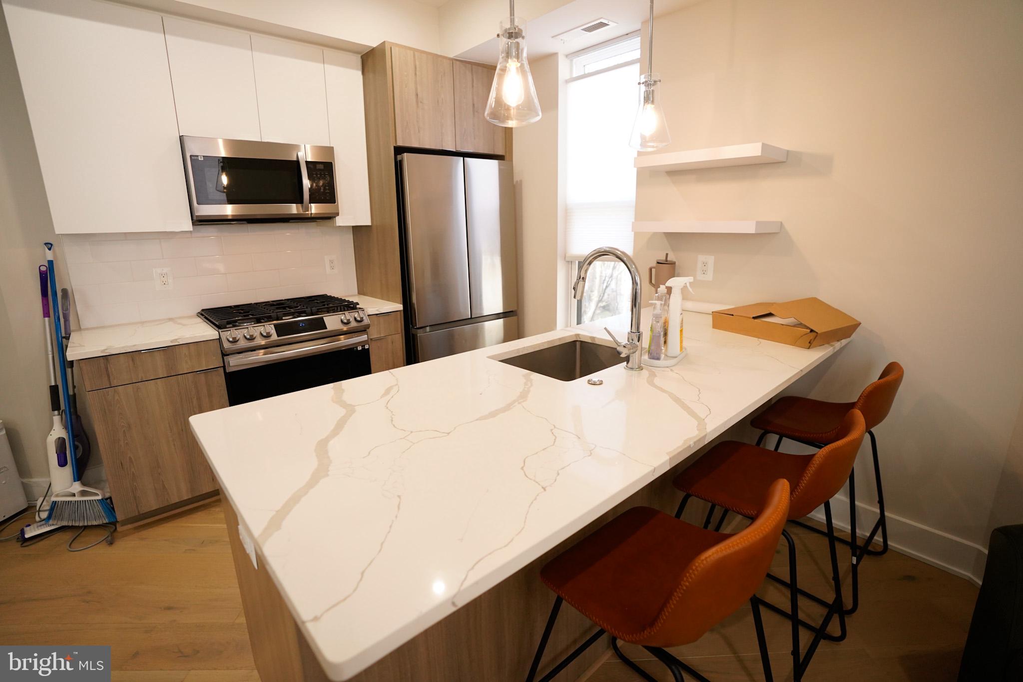 1421 Spring Road Northwest Washington, DC 20010 - Photo 7 of 12 Modern kitchen with sleek finishes.