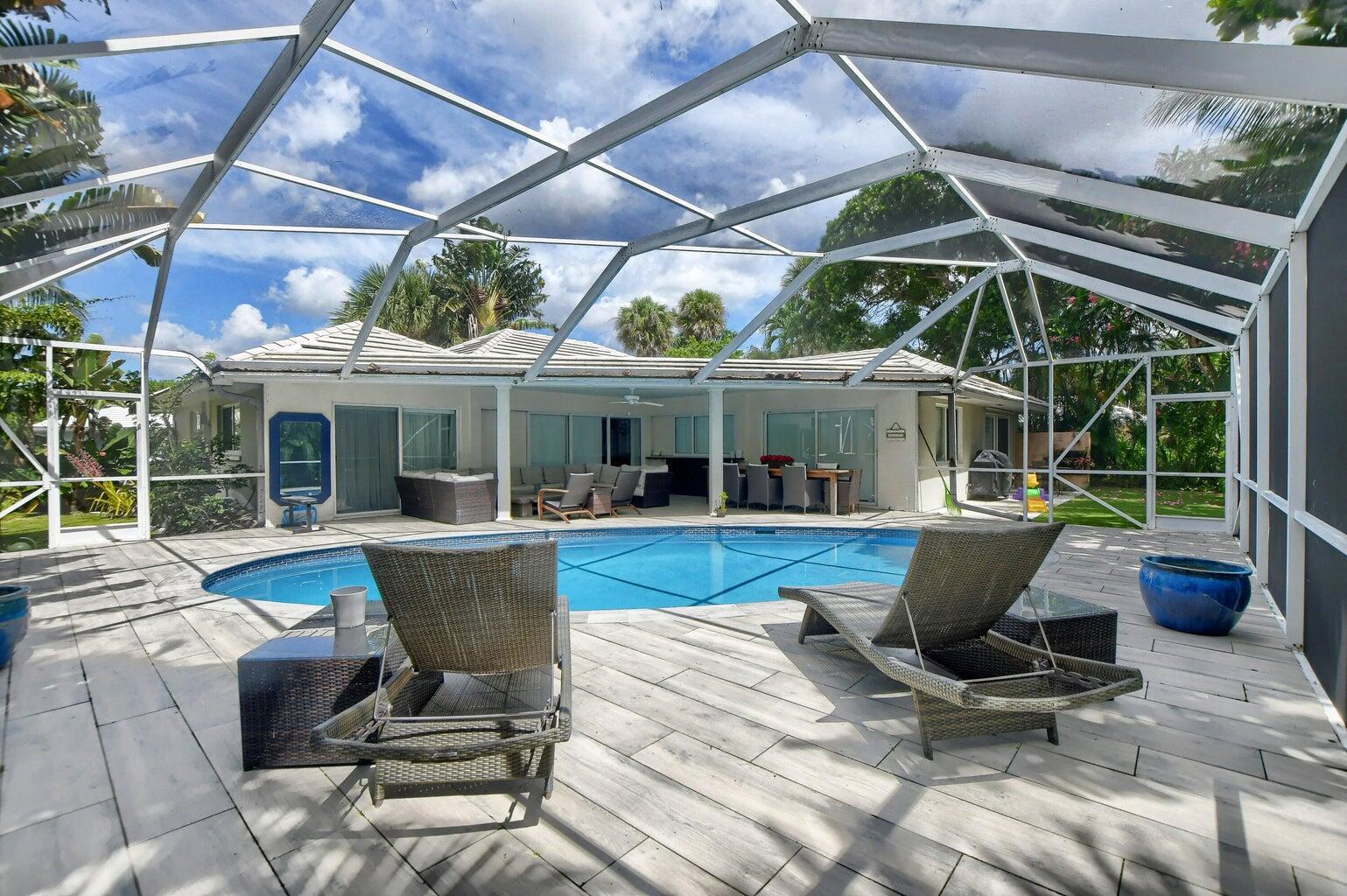 880 Hickory Terrace Boca Raton, FL 33486 - Photo 33 of 38 a view of house with swimming pool outdoor seating and house in the background