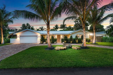a front view of a house with garden and patio