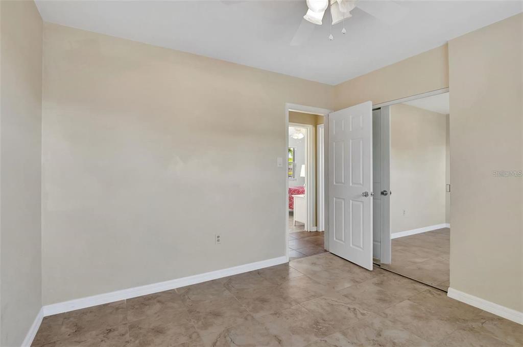 250 Bangsberg Road Southeast Port Charlotte, FL 33952 - Photo 16 of 59 an empty room with chandelier fan and closet