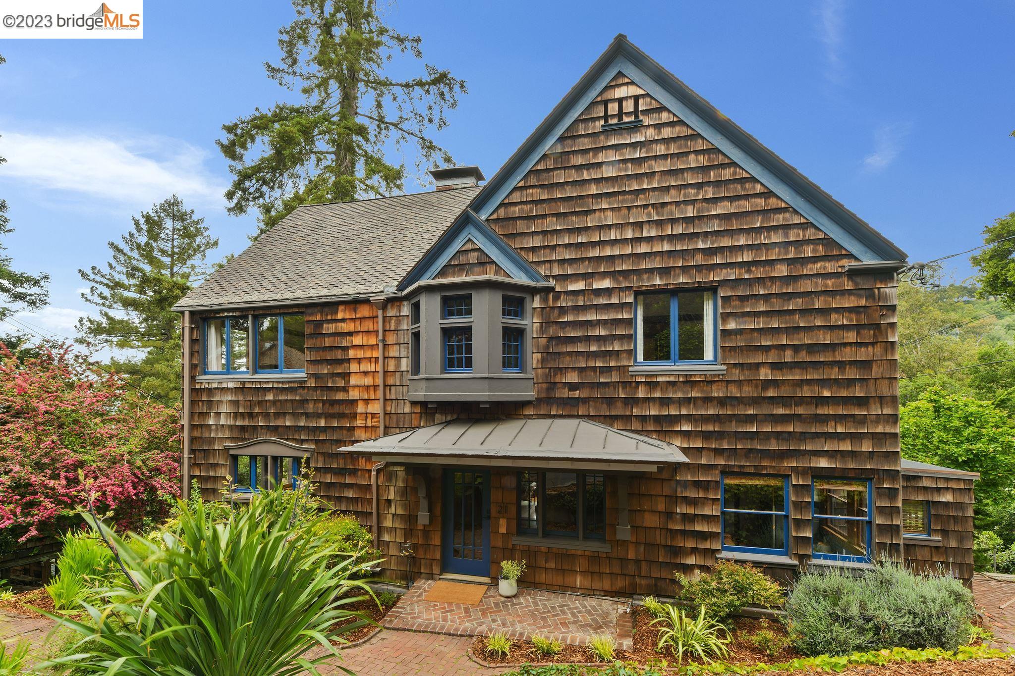 a view of a house with a yard and potted plants