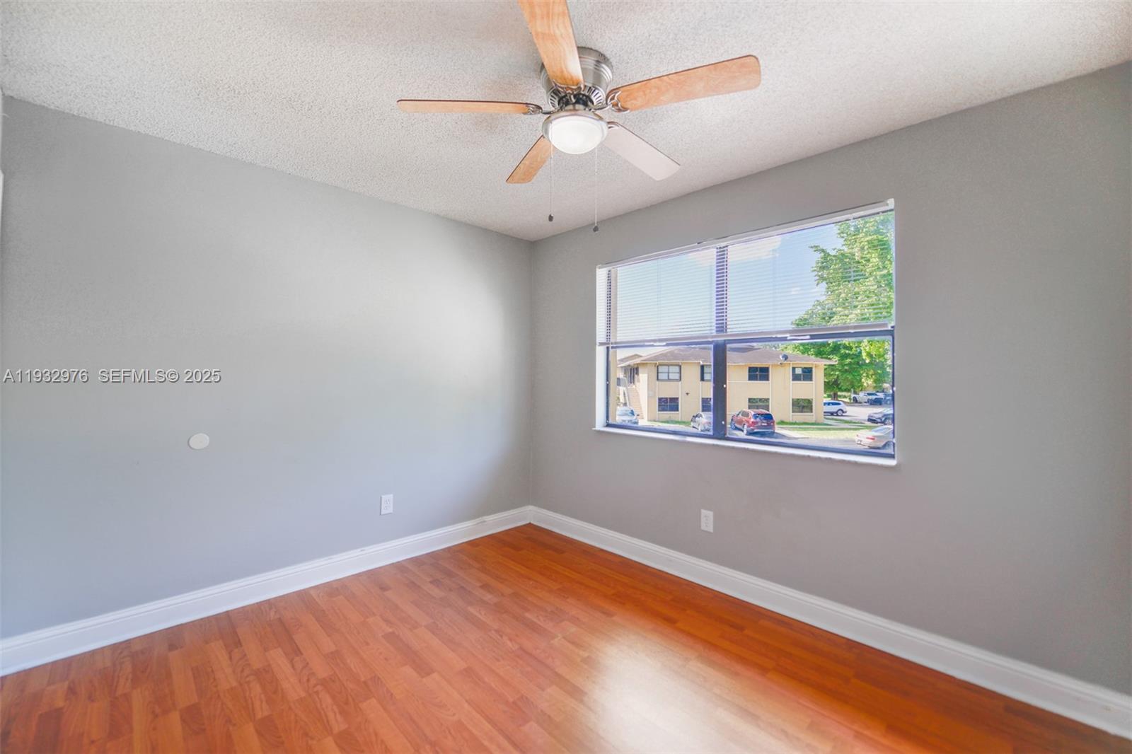 2570 West 67th Place, Unit 212 Hialeah, FL 33016 - Photo 17 of 33 wooden floor in an empty room with a window