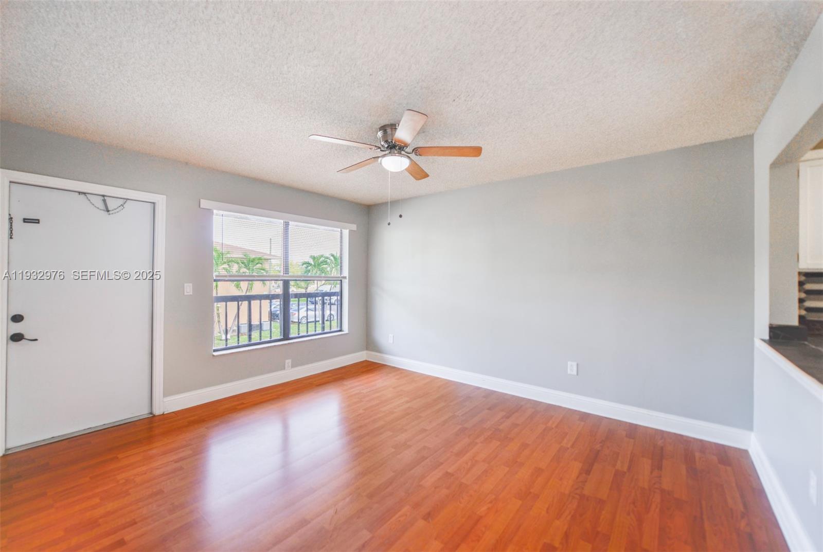2570 West 67th Place, Unit 212 Hialeah, FL 33016 - Photo 5 of 33 wooden floor in an empty room with a window