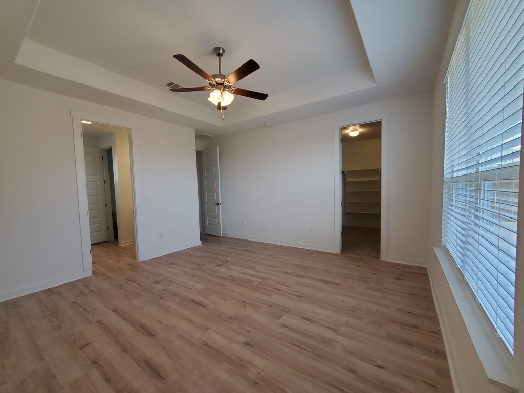 648 Peace Pipe Way Georgetown, TX 78628 - Photo 4 of 12 a view of an empty room with wooden floor and a window