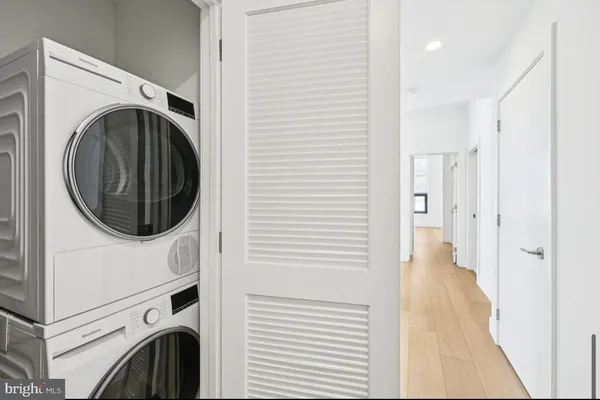 a view of a hallway with washer and dryer