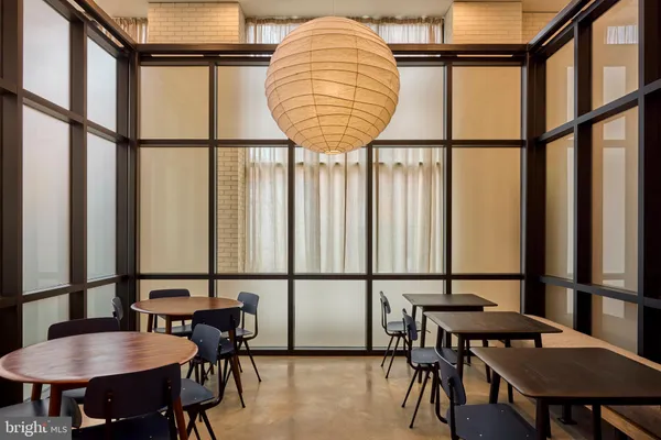 a dining room with furniture and a window