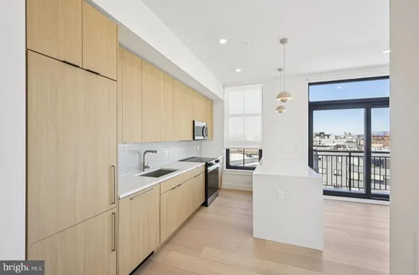 a kitchen with counter top space and sink