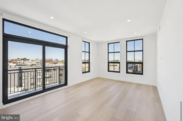 a view of an empty room with window and cabinet