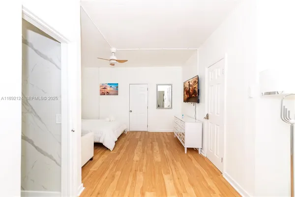 a bedroom with a bed and a glass door